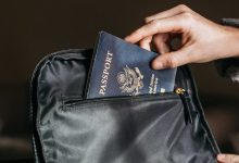 person putting a passport on bag