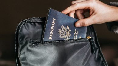 person putting a passport on bag